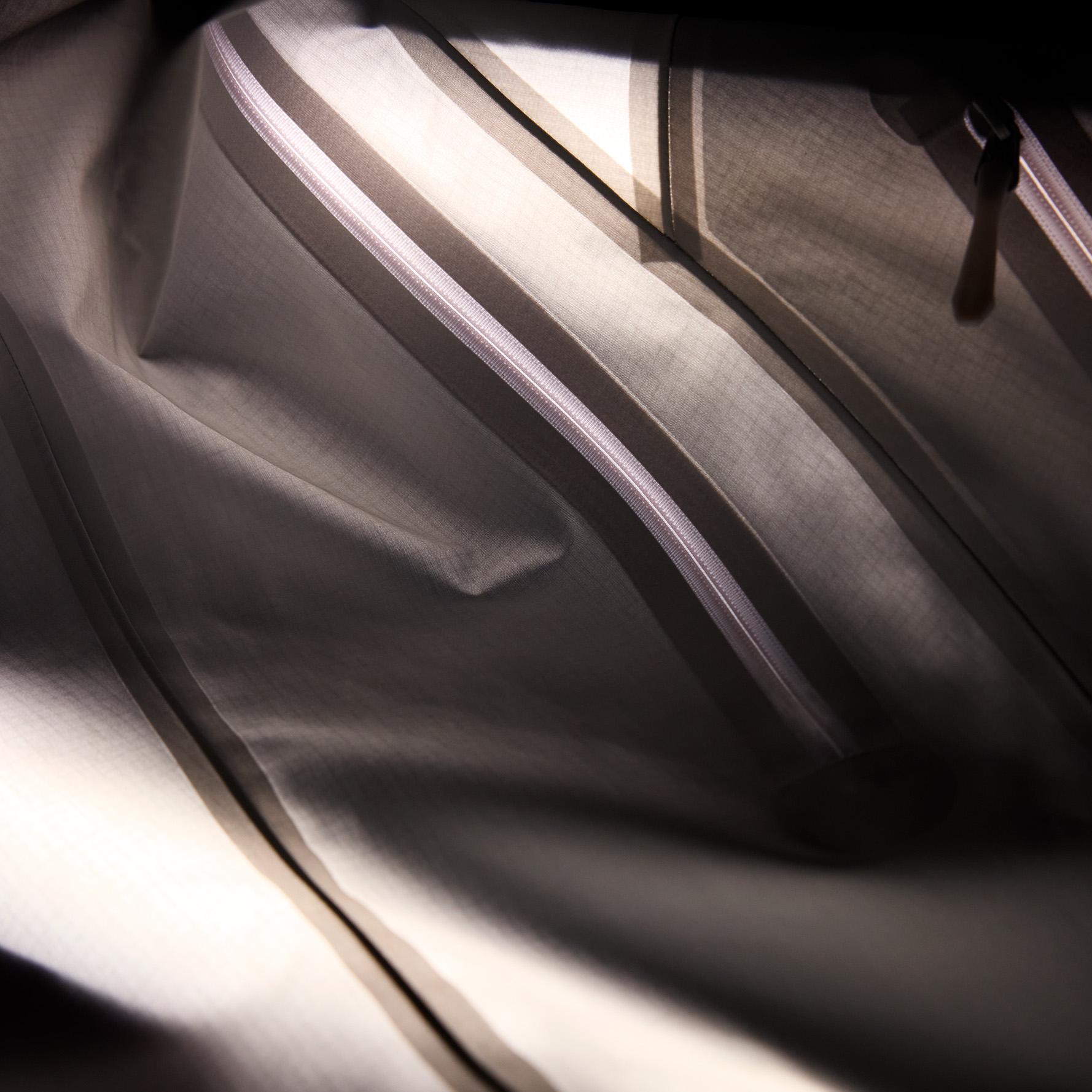 Inside of a bag with zippers and fabric folds.