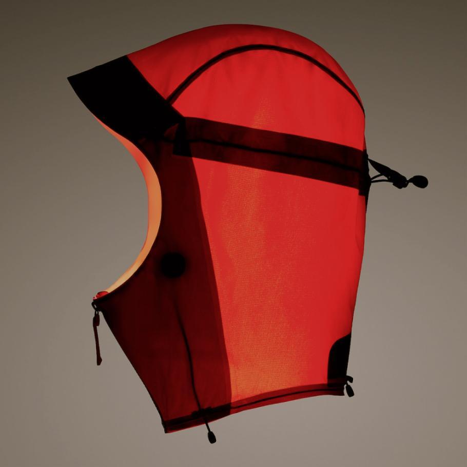 a close up of a red hood from a shell jacket on a brown background