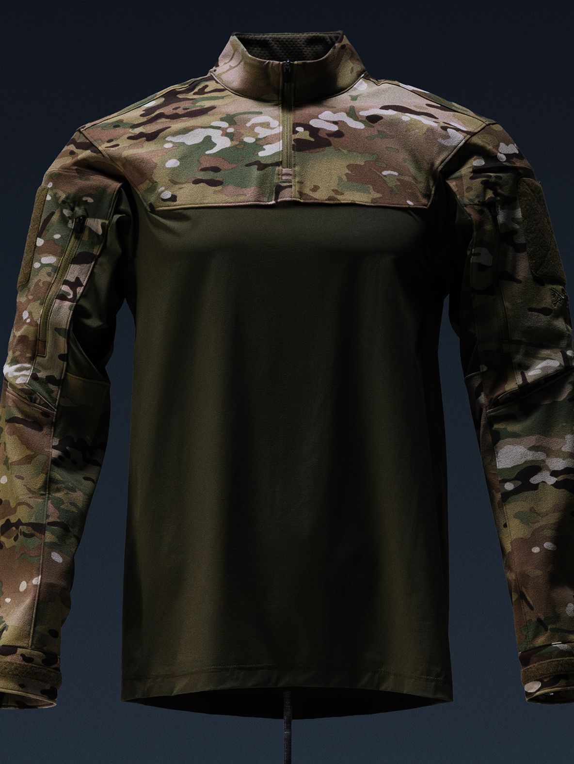A tactical combat shirt with an olive green body, Multicam camouflage sleeves, and a quarter-zip collar.