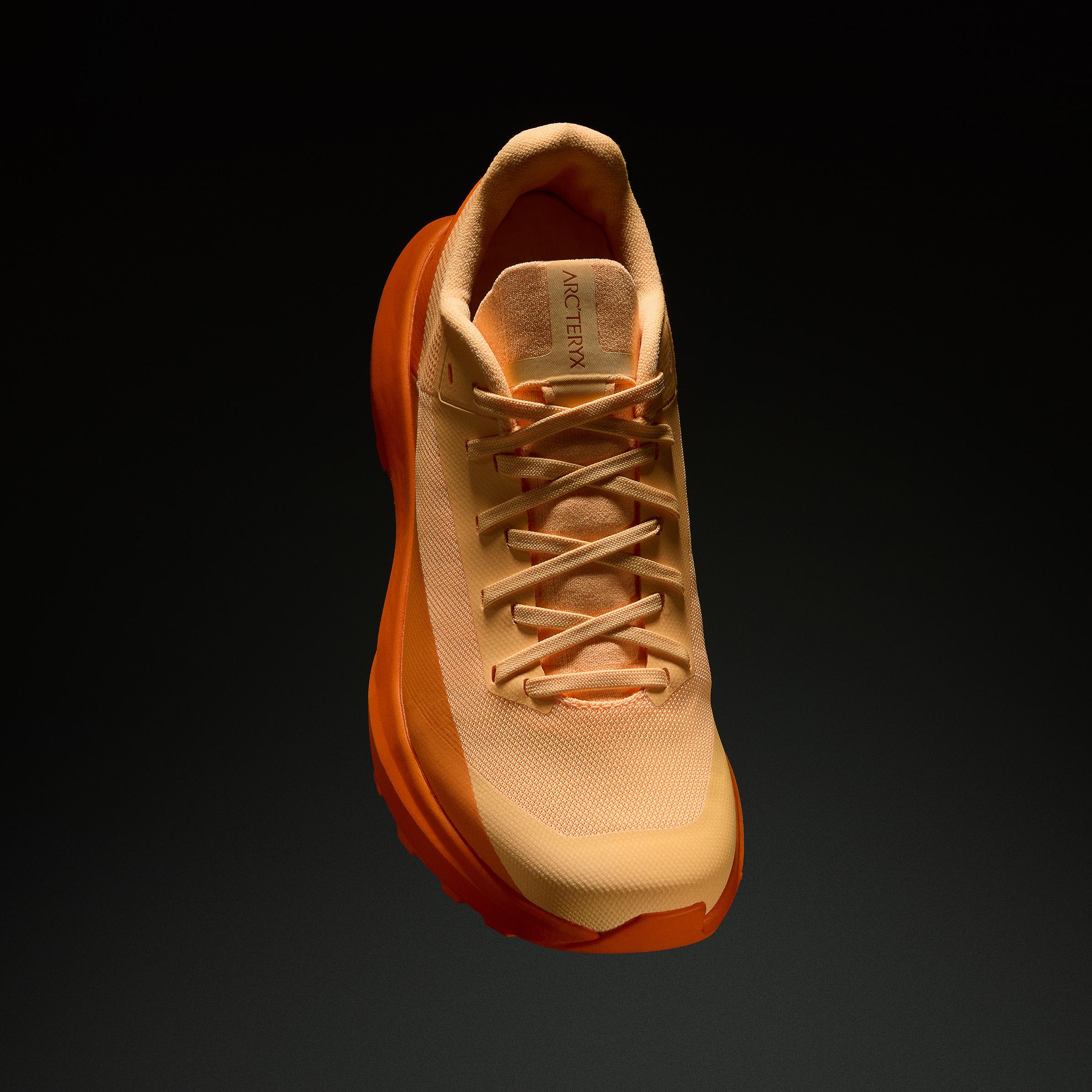 a close up of a pair of running shoes on a black background