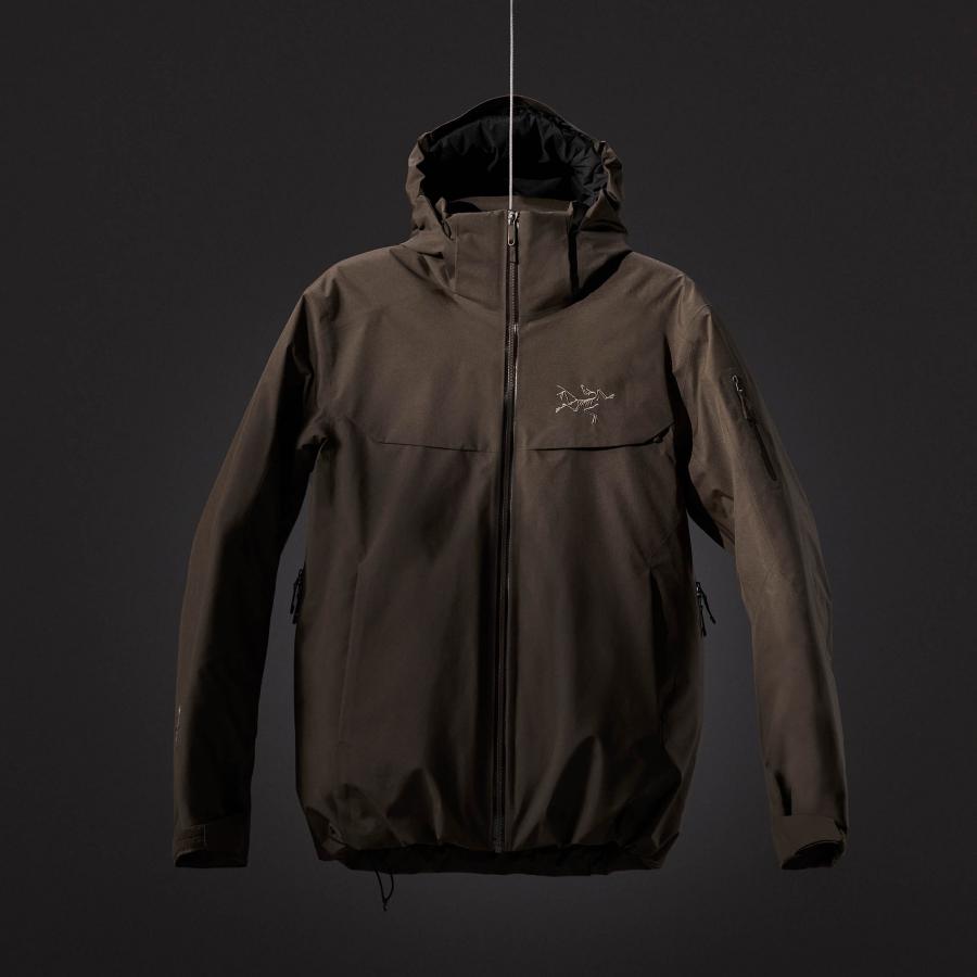 a brown jacket with a hood is hanging from a string on a black background .