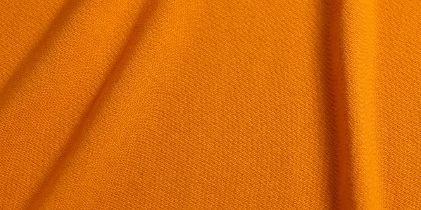 Orange fabric with soft folds.