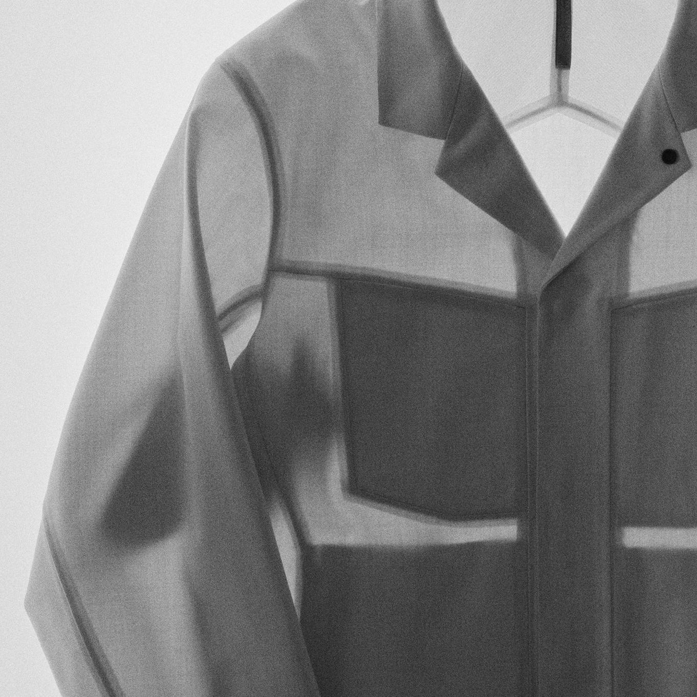 a black and white photo of a shirt hanging on a hanger.