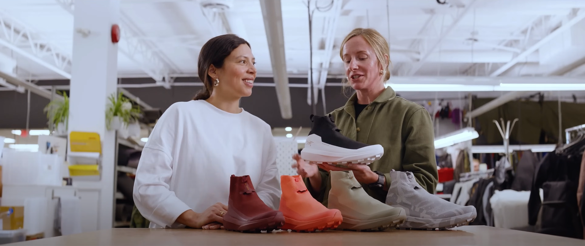 Two women with a display of colorful high-top shoes.