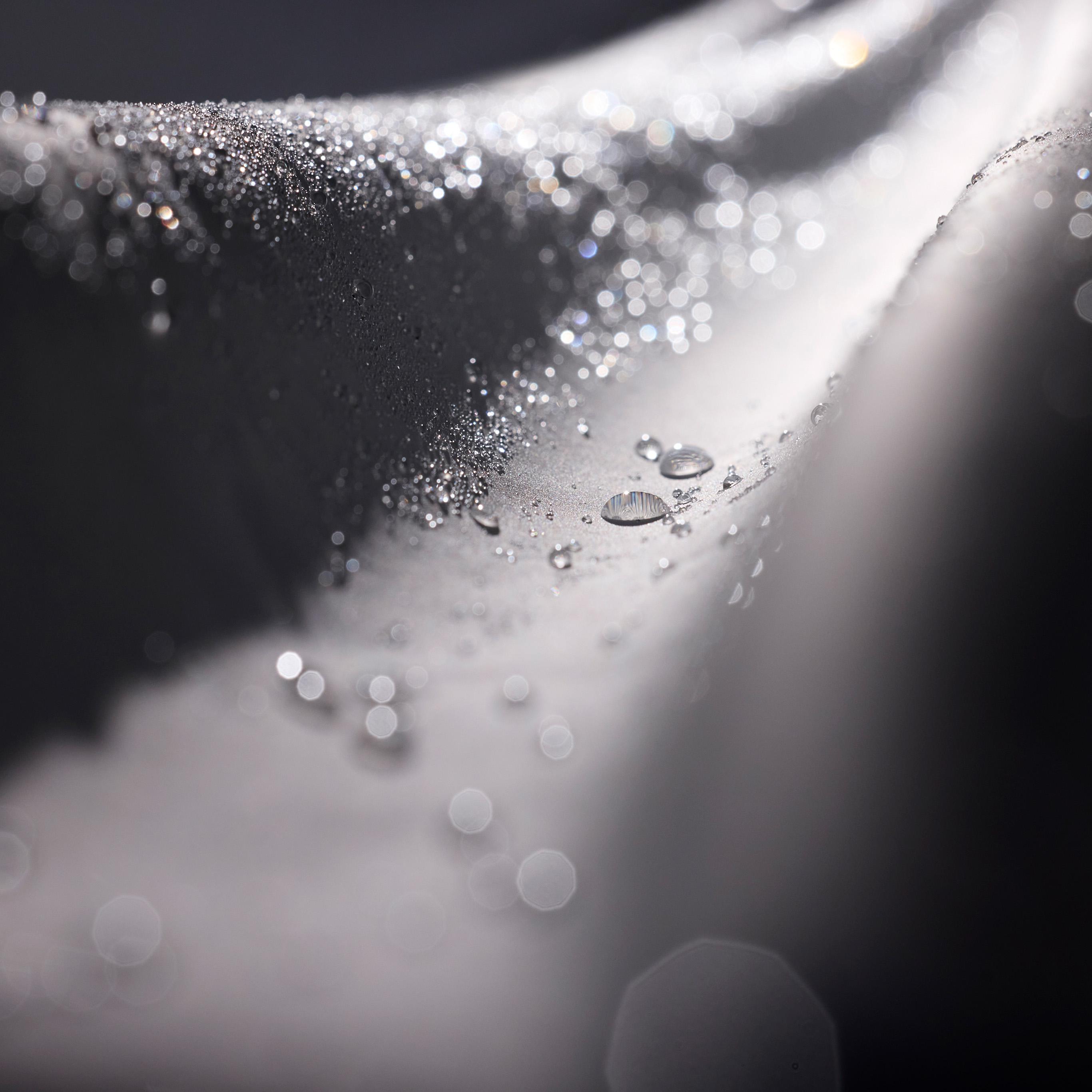a close up of water drops on a white surface .