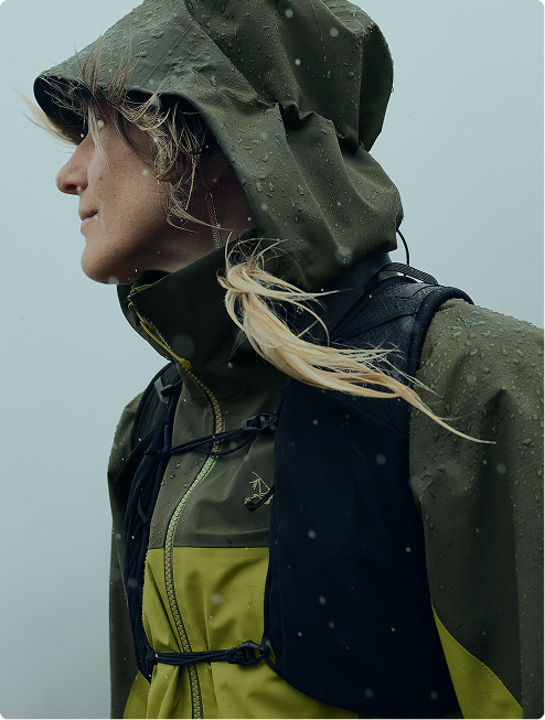 A woman wears a black Arc'teryx jacket and beanie.
