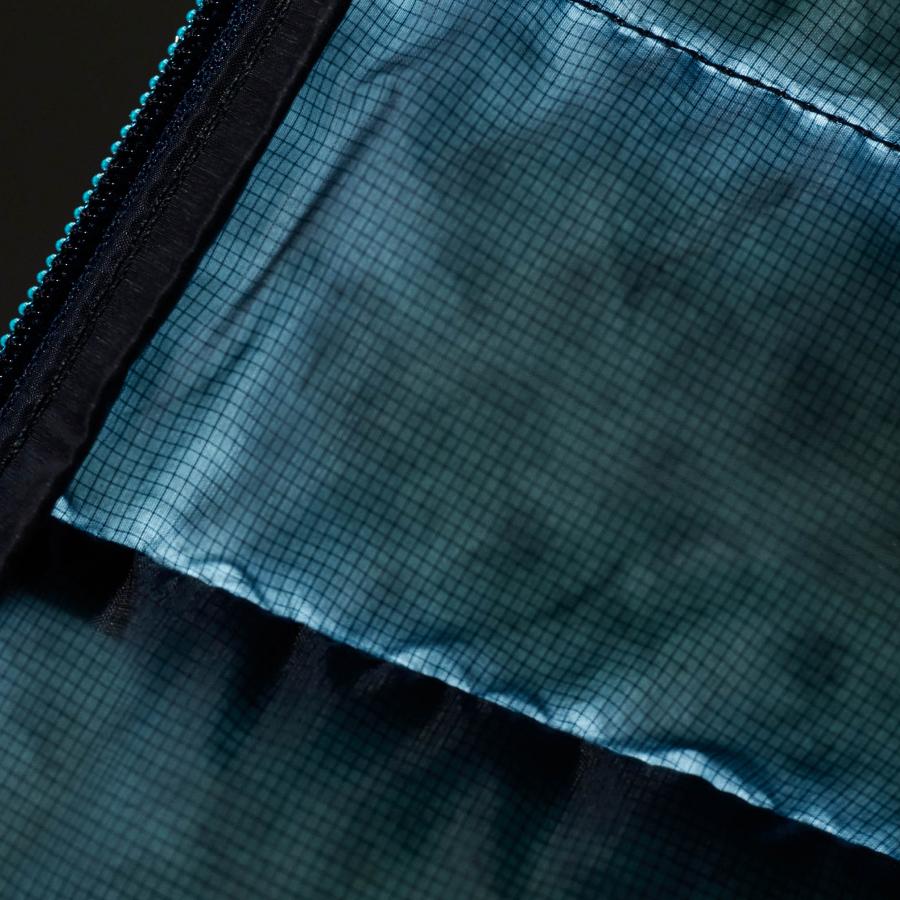 a close up of the inside of a blue bag with a zipper .