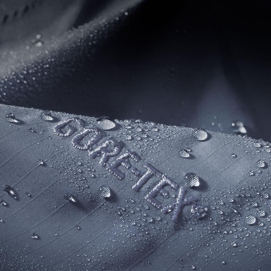 a close up of a waterproof shell jacket with water drops on it