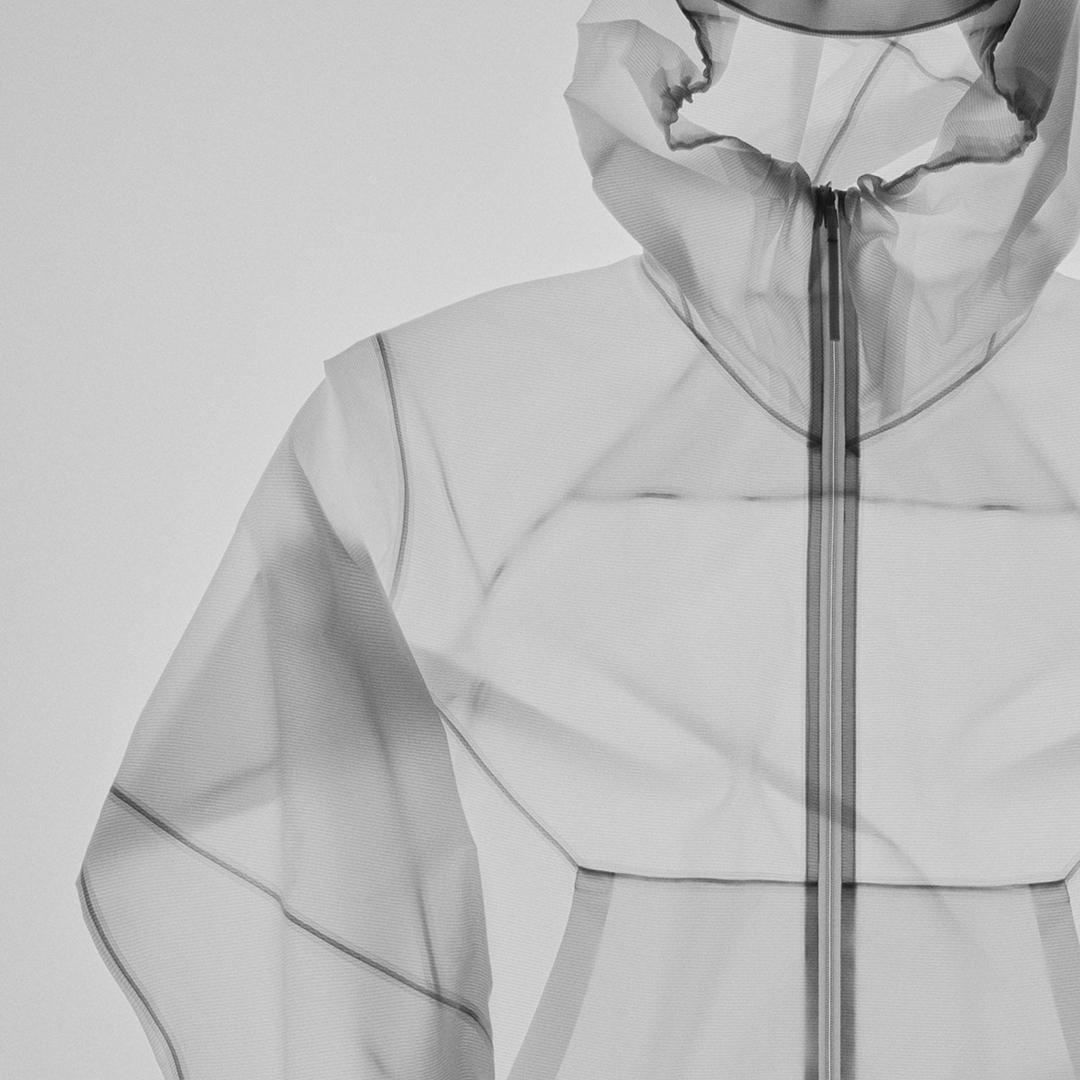 Translucent gray hooded jacket with exposed seams and zipper.