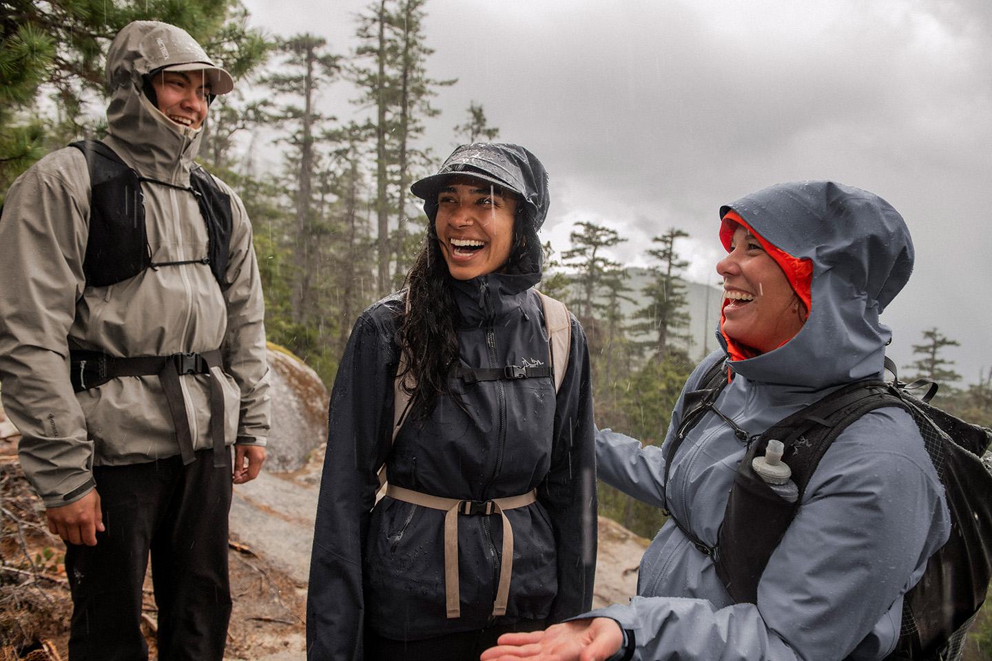 a group of people are standing next to each other in the rain wearing waterproof, GORE-TEX rain jackets