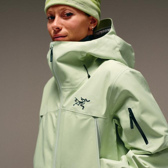 Woman in a light green Arc'teryx jacket and green beanie.