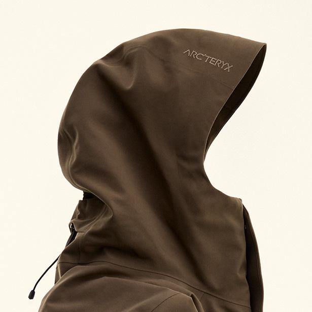 Dark olive green Arc'teryx jacket hood with logo and drawstring.