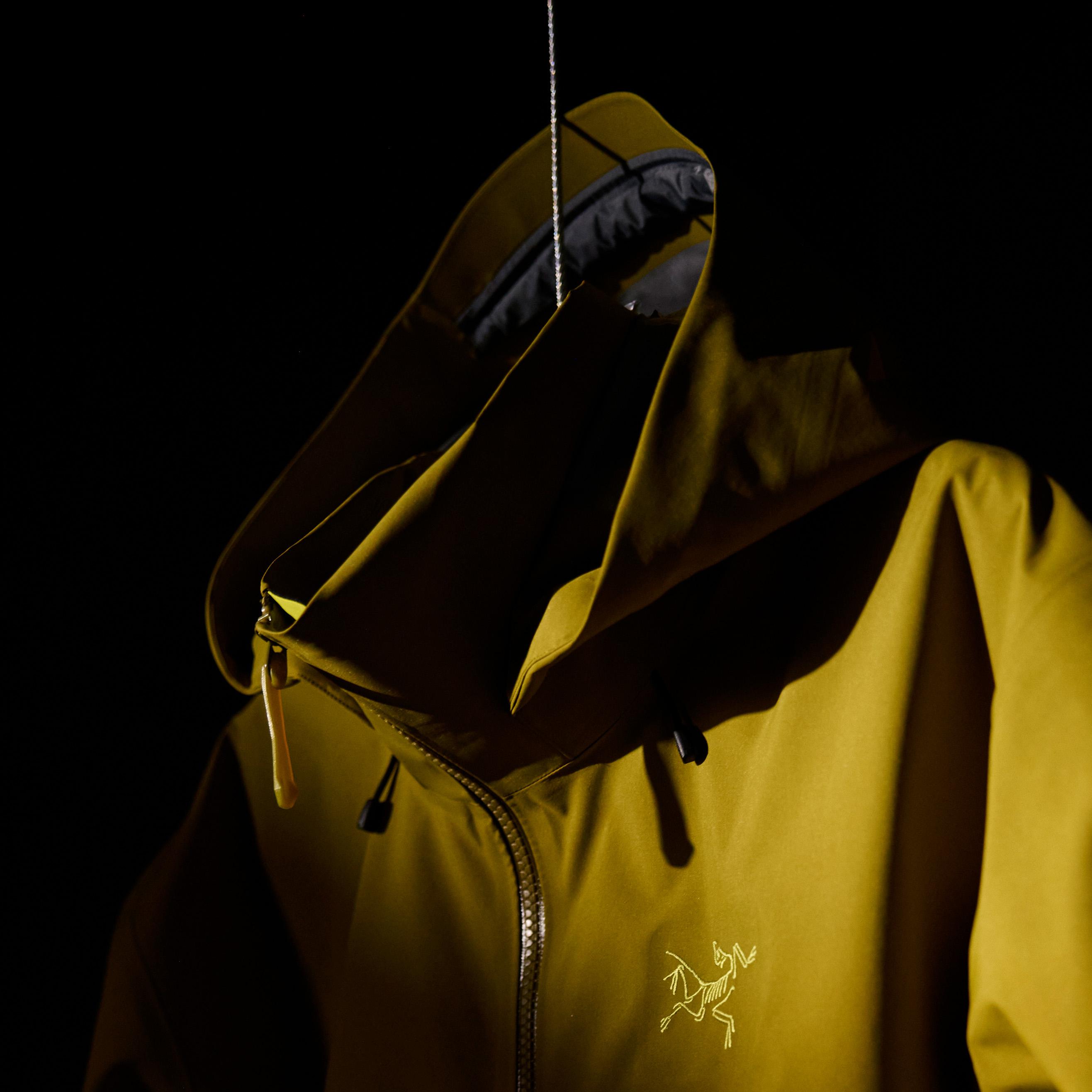 a yellow jacket with the word arcteryx on it