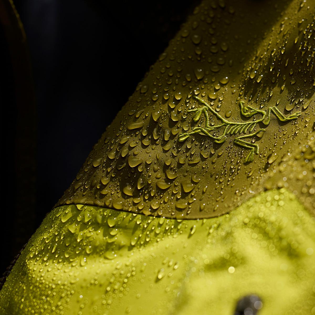 Yellow Arc'teryx jacket covered in water beads.