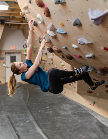 An Arc'teryx employee bouldering at the office