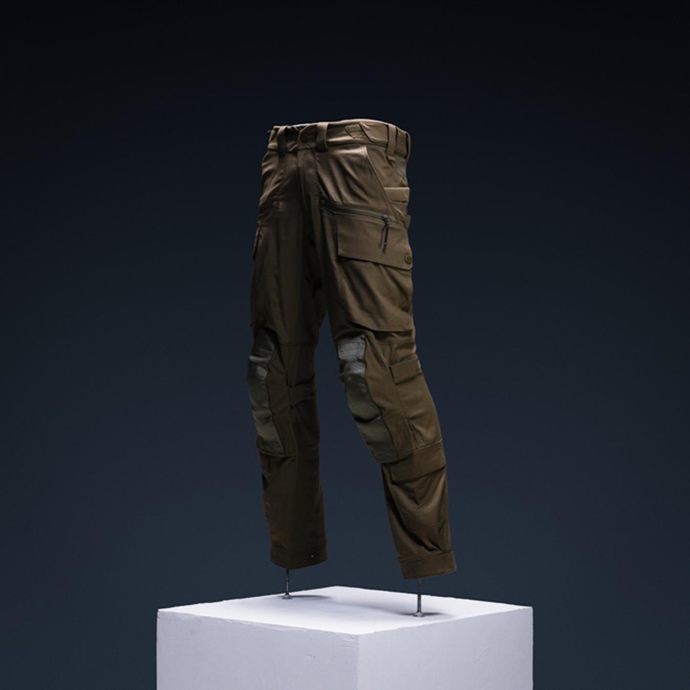 Olive green tactical cargo pants with integrated knee pads.