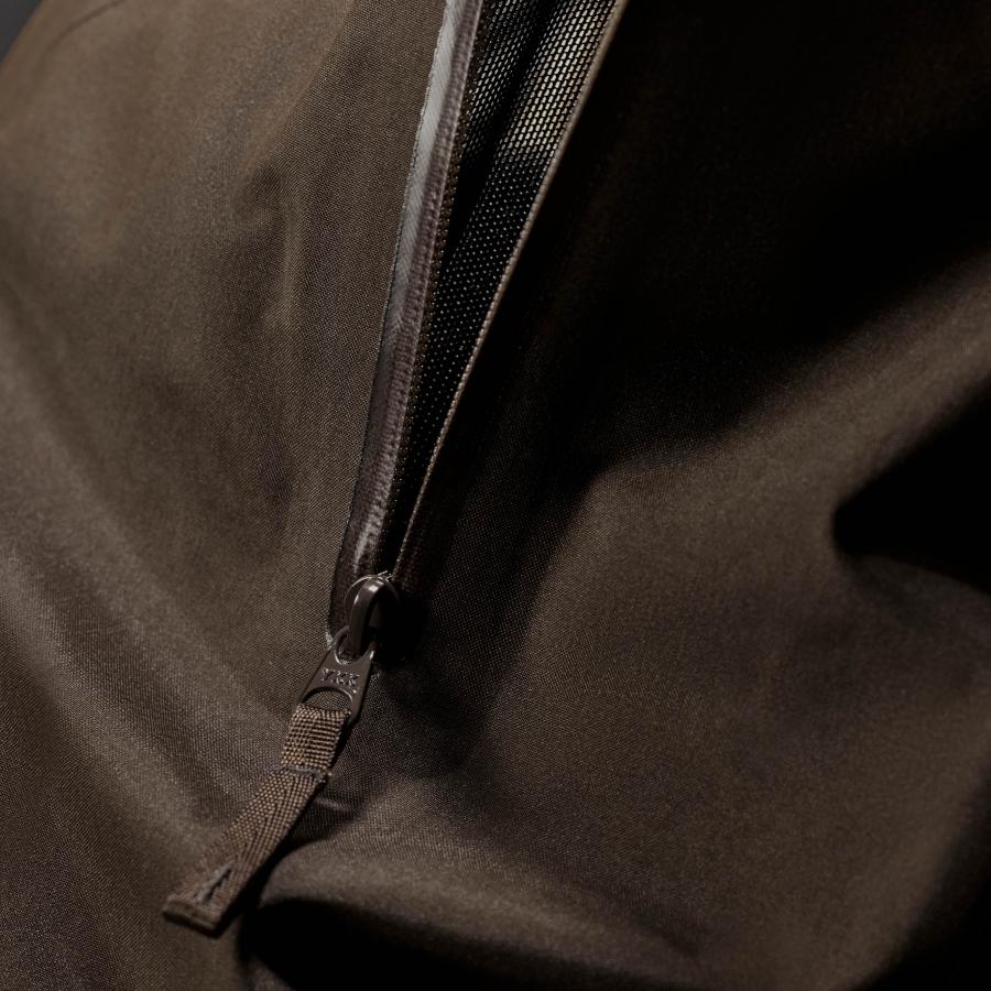 a close up of a zipper on a brown jacket