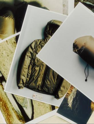 Overlapping photos displaying an olive-green hooded puffer jacket and its rolled-up stuff sack.