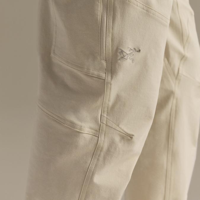 Close-up of light beige pants with an embroidered Arc'teryx logo.