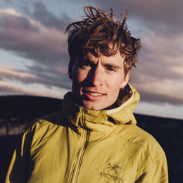 a man wearing a yellow jacket that says arcteryx