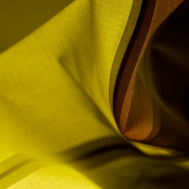 a close up of a piece of yellow and brown fabric