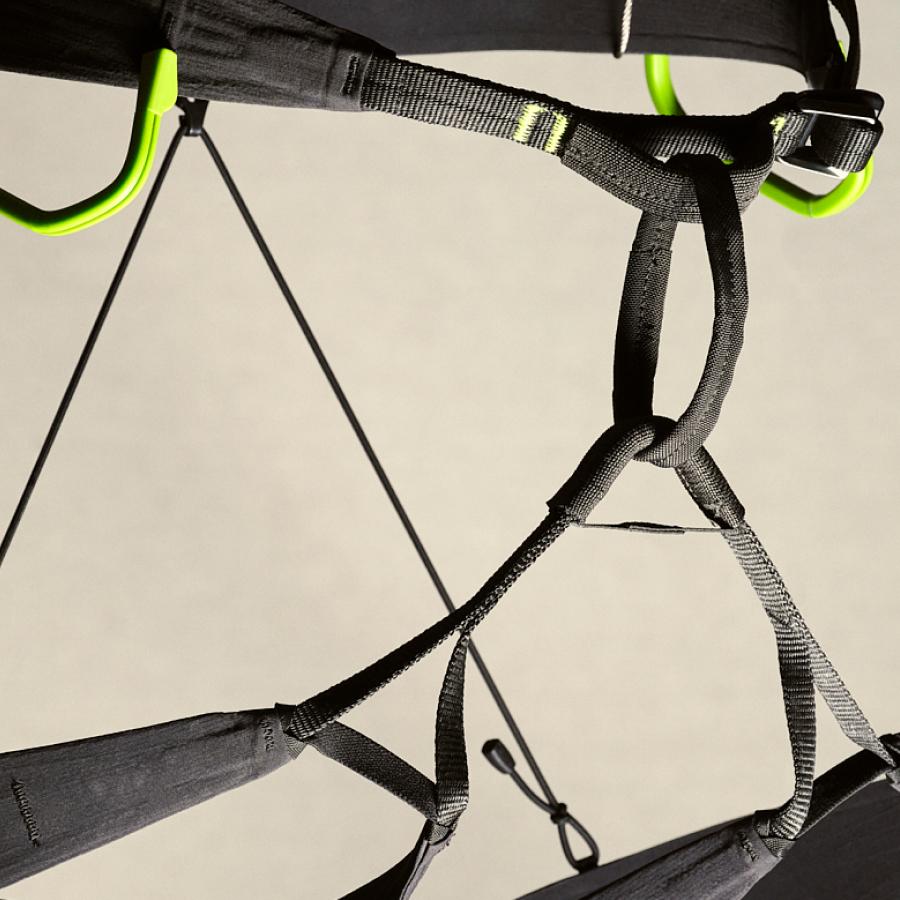 Lightweight black harness with green attachment loops.
