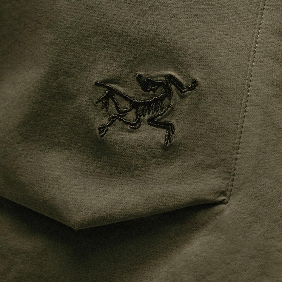 Arc'teryx logo embroidered on dark olive green fabric.