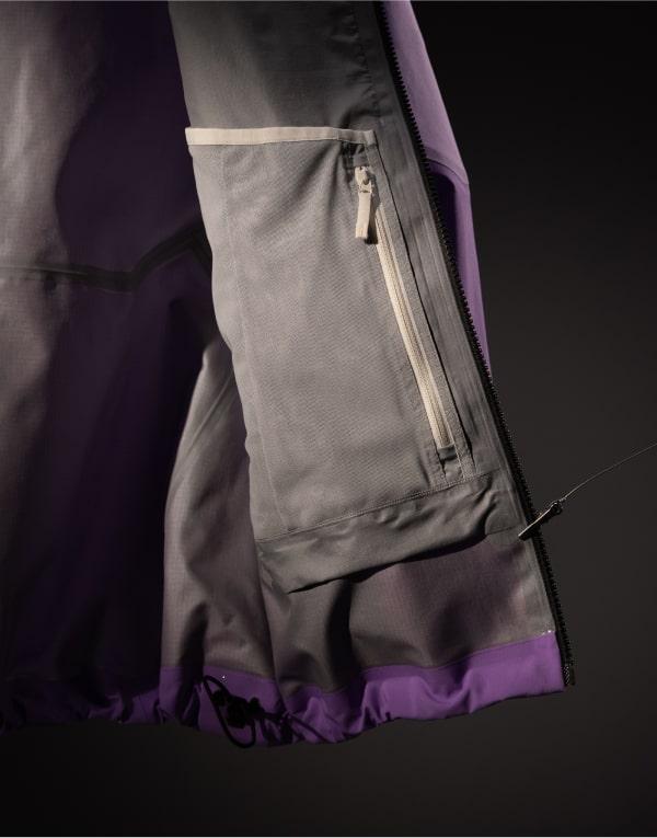 the inside of a purple jacket with a white zipper