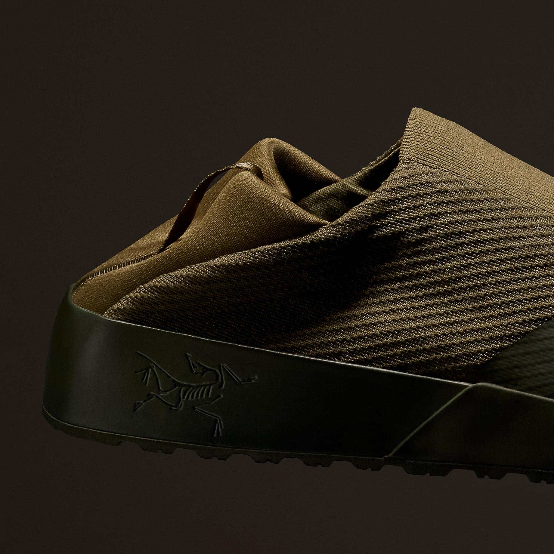 a close up of a pair of shoes with a collapse heel and logo on the side