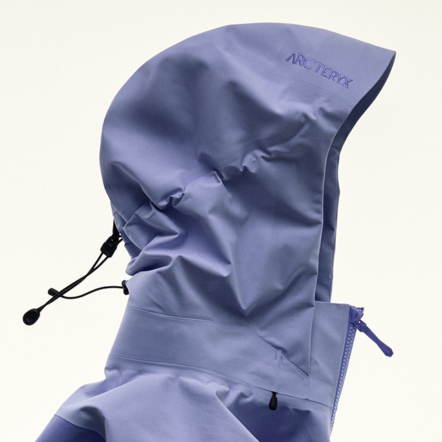 Lavender Arc'teryx jacket hood with logo and drawstrings.