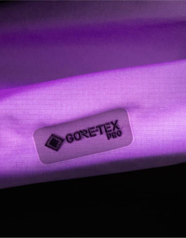 a close up of a purple fabric with a purple label on it .