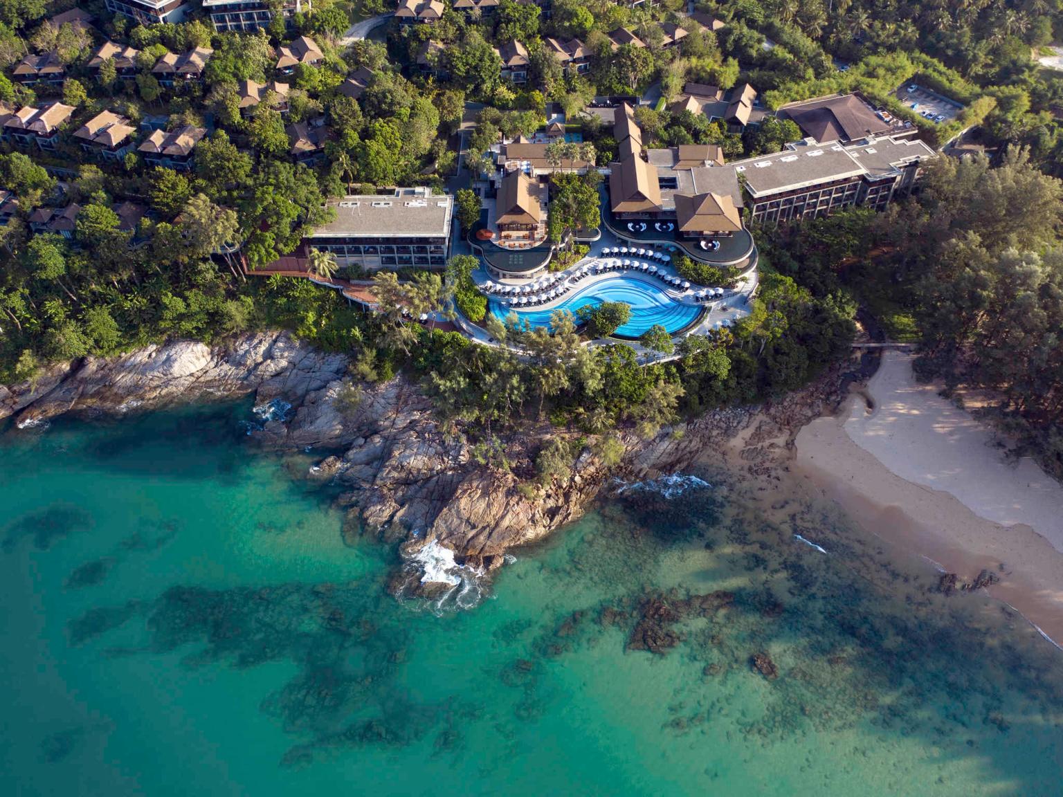 an aerial view of a resort on a cliff overlooking the ocean