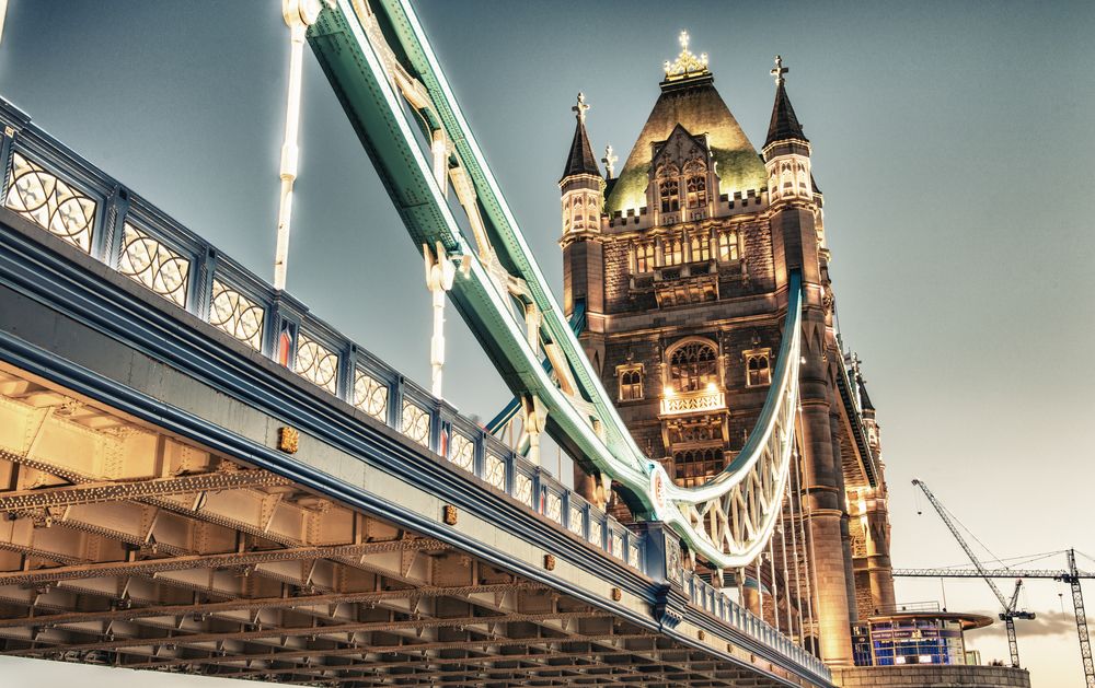 Illuminated Tower Bridge at twilight from a low angle. London
