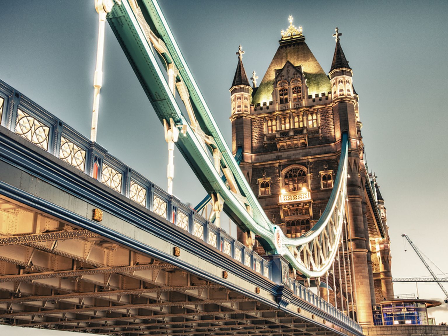 Illuminated Tower Bridge at twilight from a low angle. London