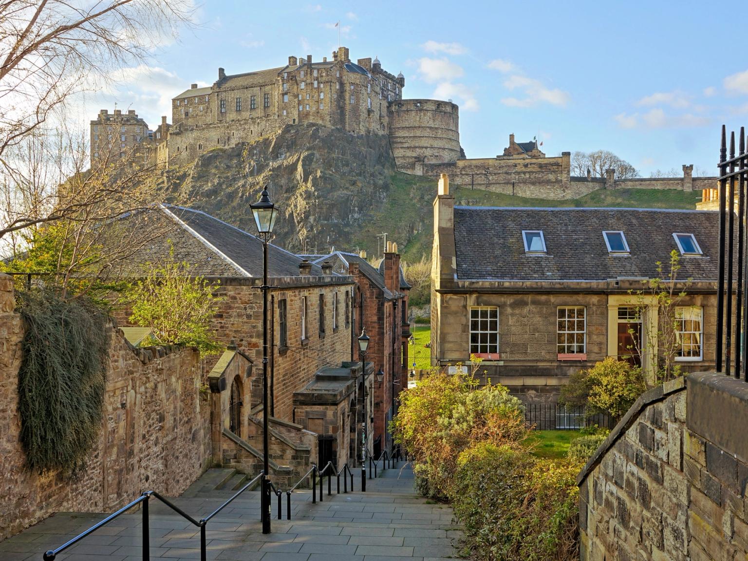 there is a castle on top of a hill in the background