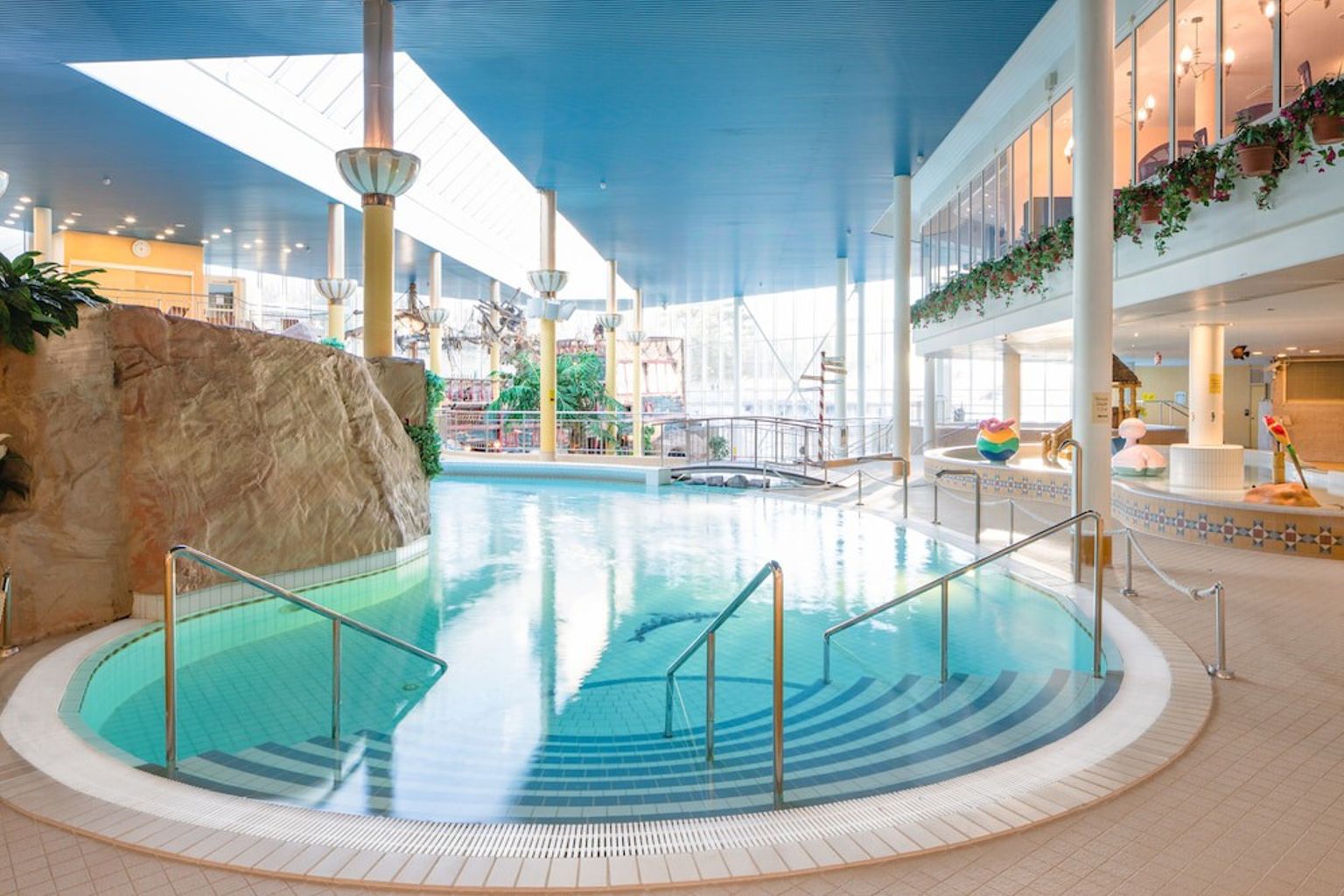 a large indoor swimming pool with stairs leading to it