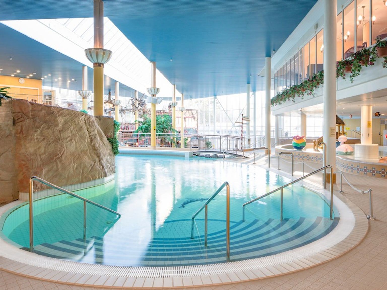 a large indoor swimming pool with stairs leading to it