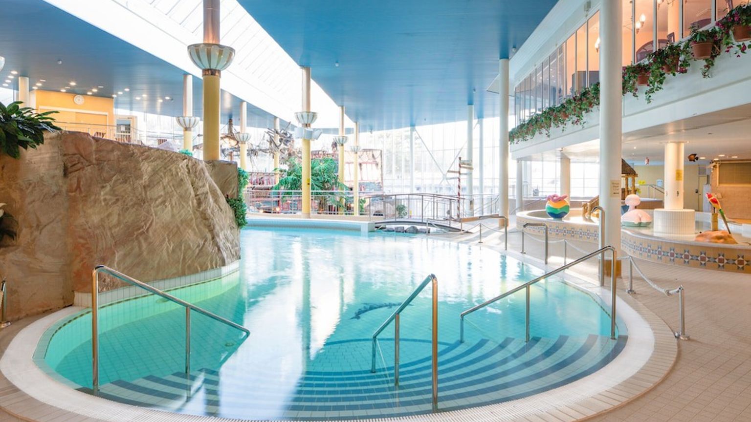 a large indoor swimming pool with stairs leading to it