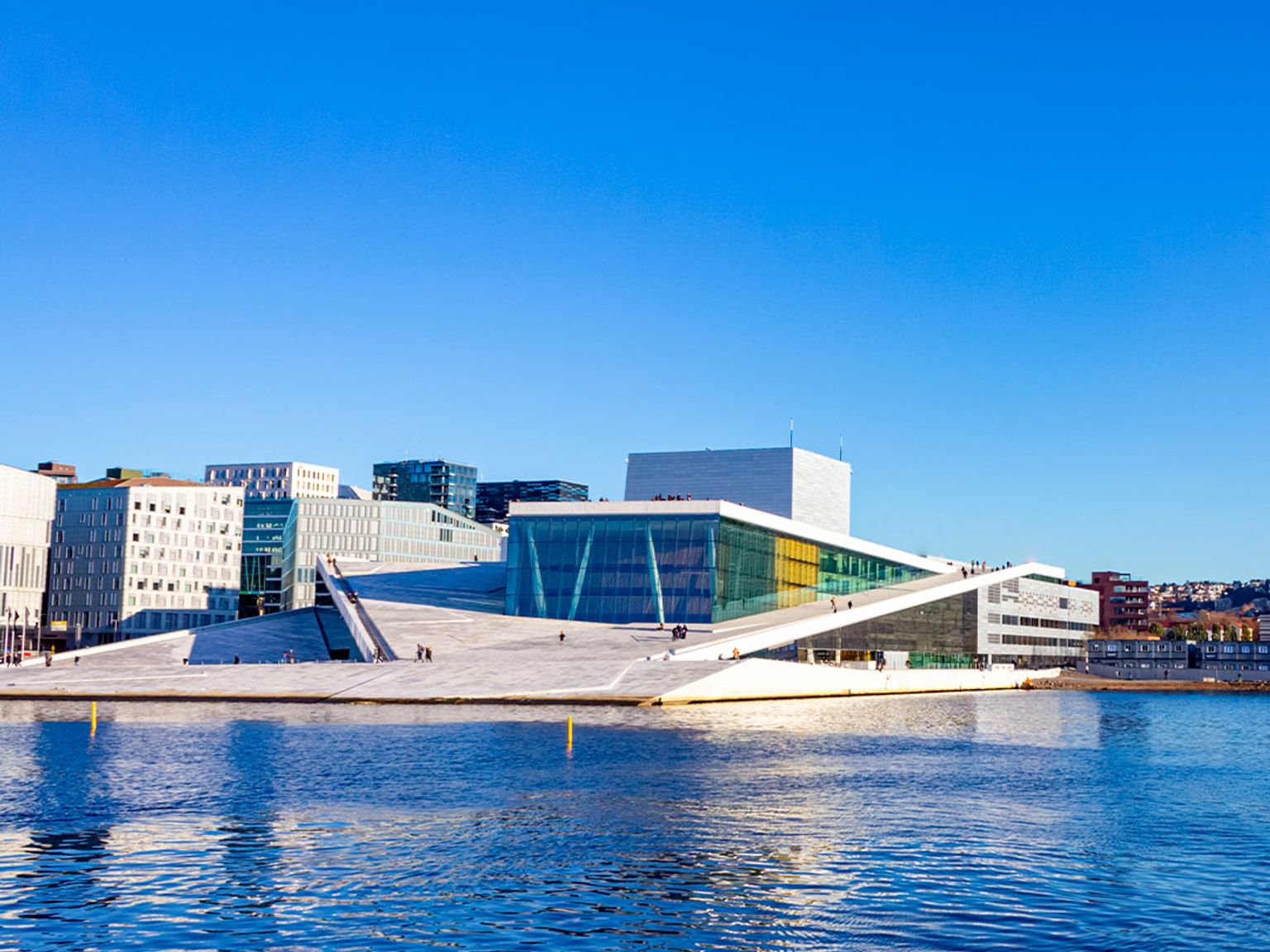 a large building is sitting on top of a body of water