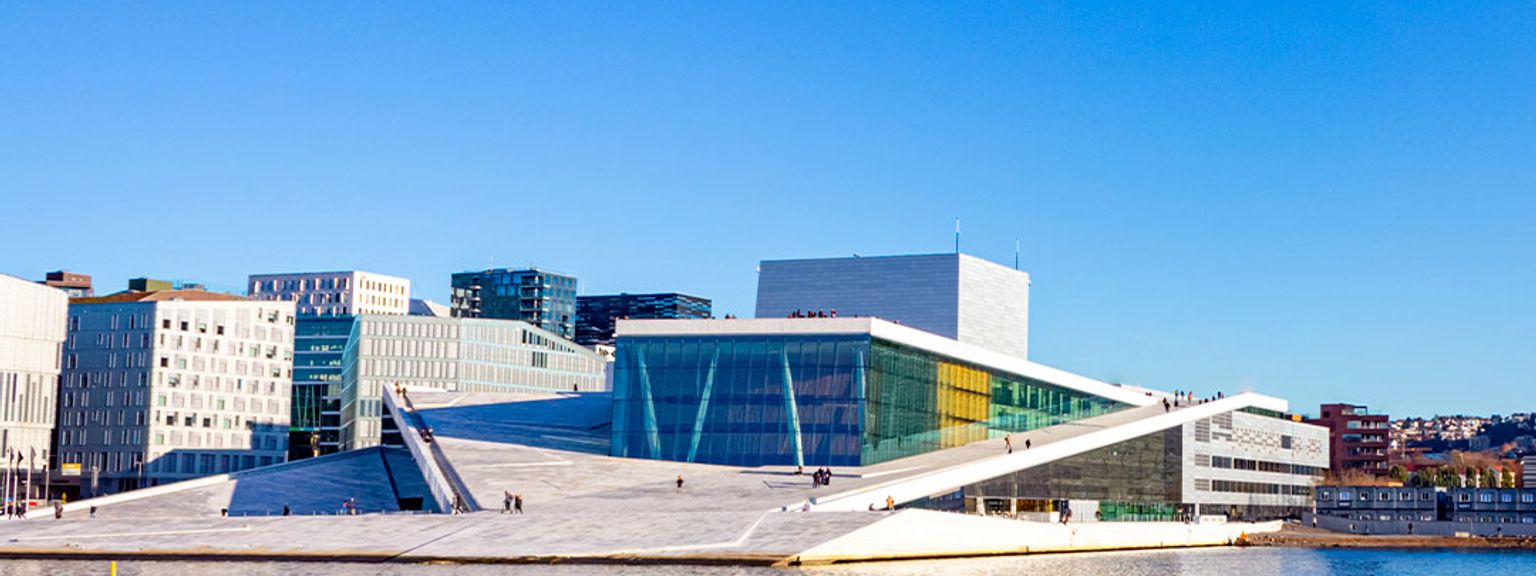 a large building is sitting on top of a body of water