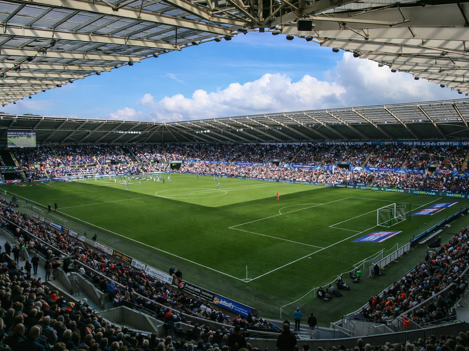 A large, packed football stadium during a match, with a clear blue sky overhead.