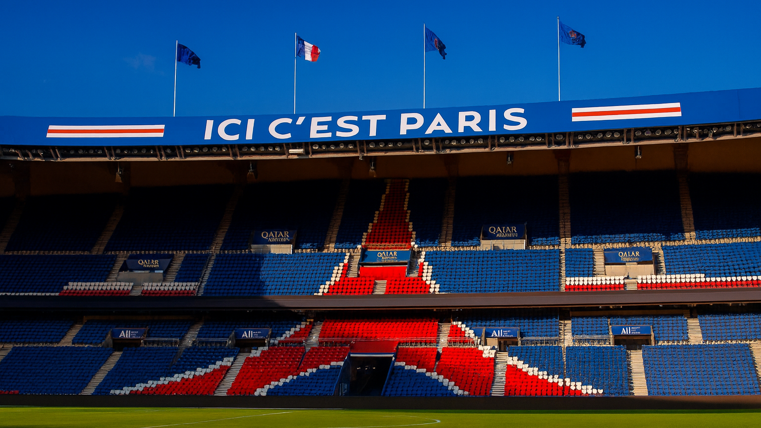 Empty Parc des Princes stadium with blue and red patterned seating and an "ICI C'EST PARIS" sign.