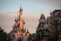das Schloss ist umgeben von Gebäuden und Bäumen in Disneyland