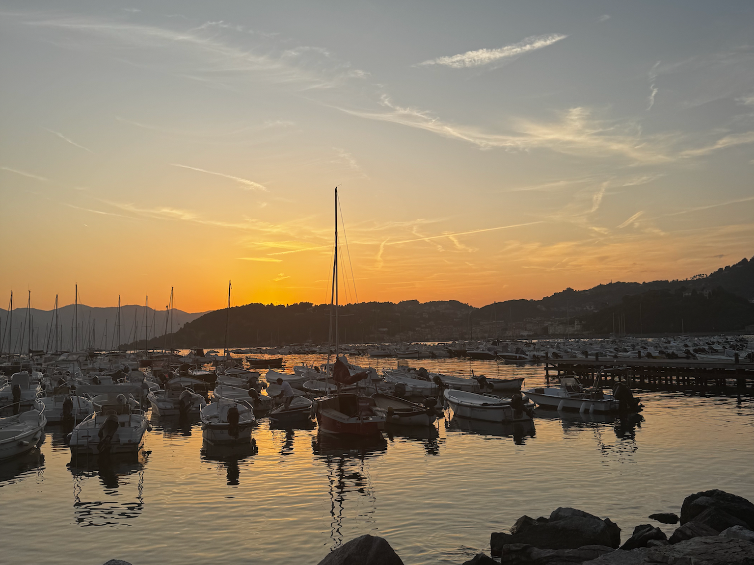 båtar är förtöjda i en hamn vid solnedgången