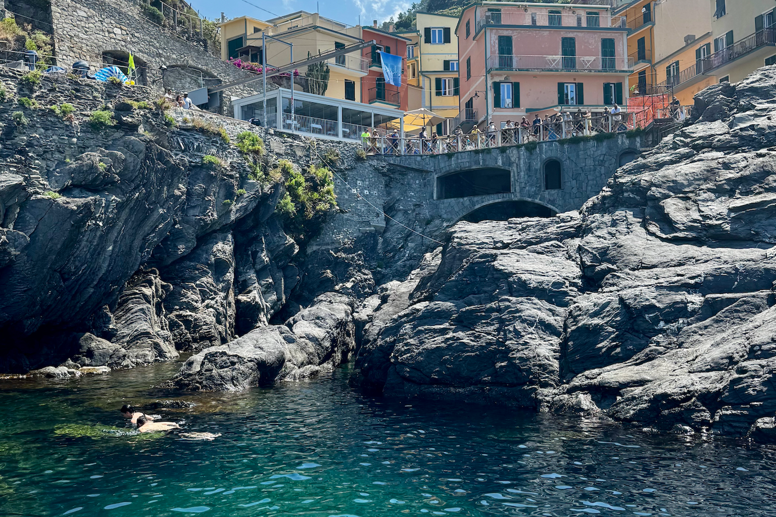 en vattenmassa omgiven av klippor och byggnader