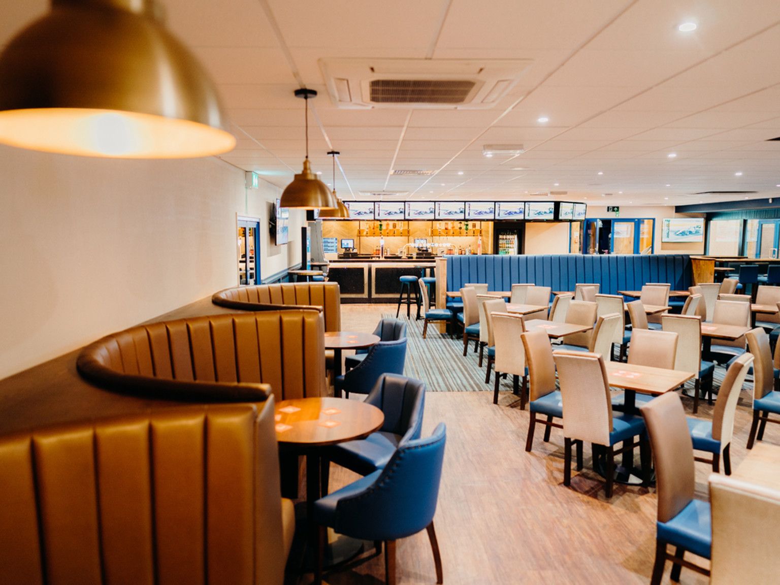 a restaurant with tables and chairs and a bar
