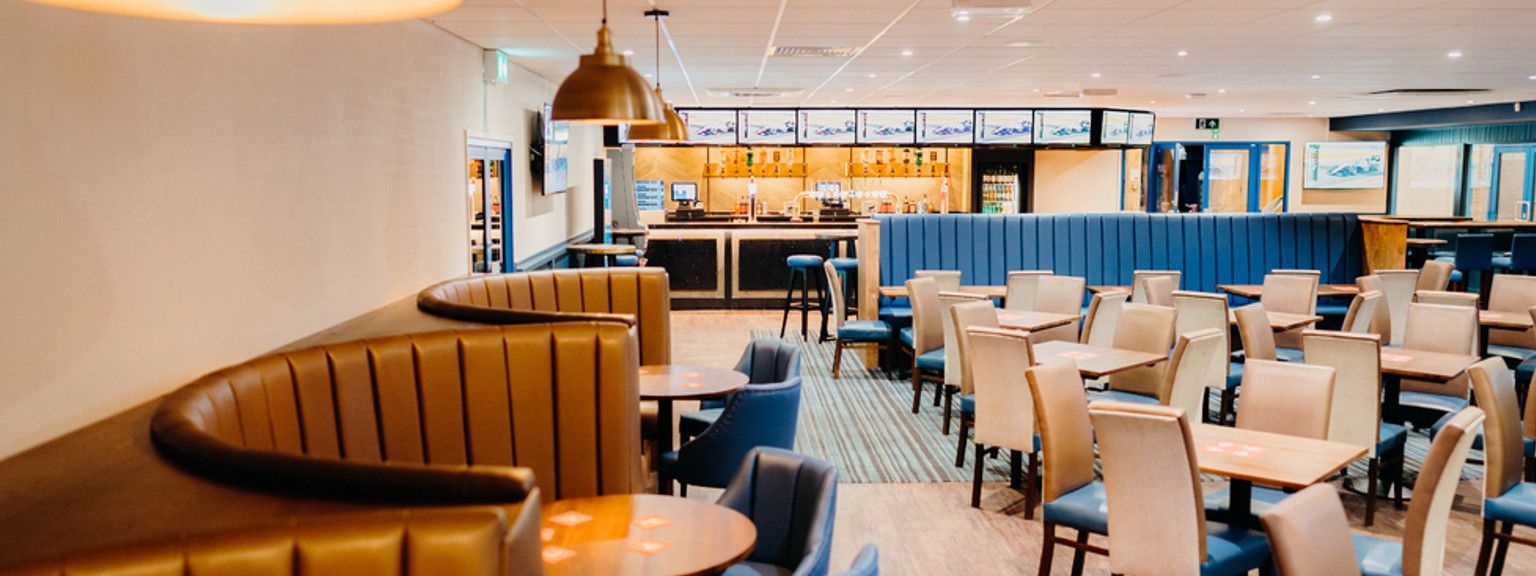a restaurant with tables and chairs and a bar