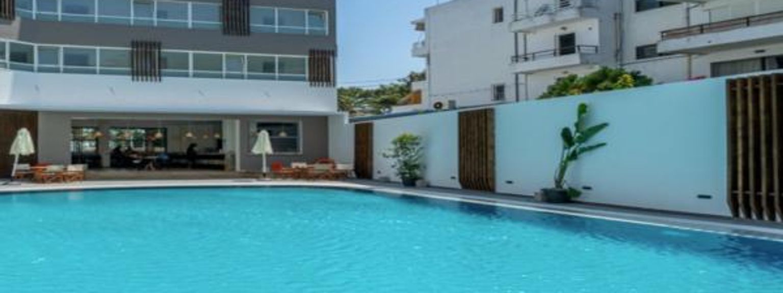 det finns en stor simbassäng framför en byggnad