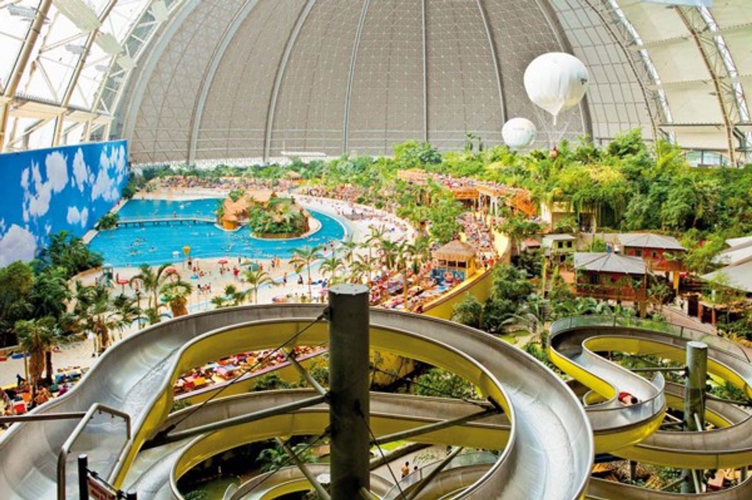 a large water park with a lot of slides and a pool