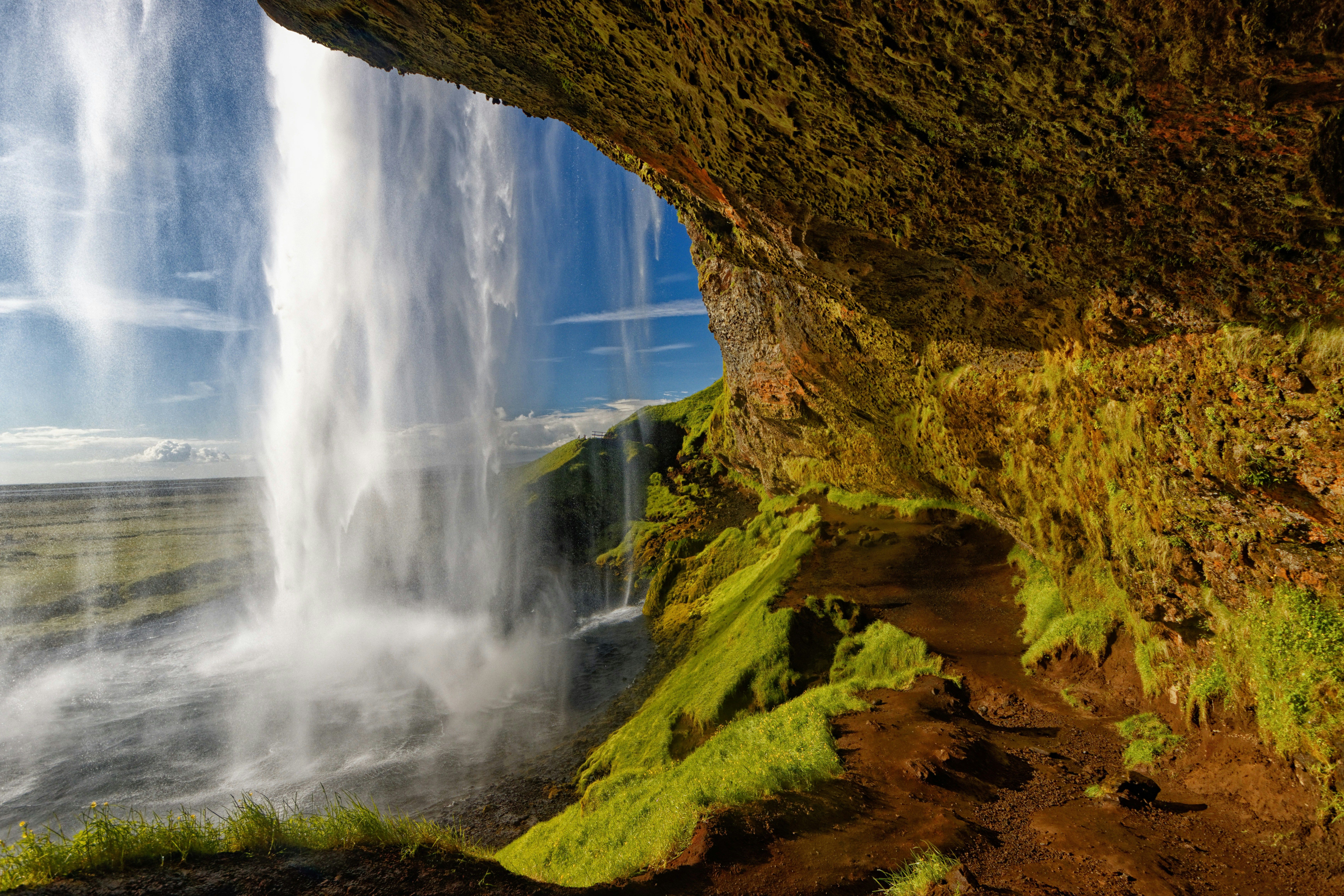 a waterfall is coming down a rocky cliff in a cave